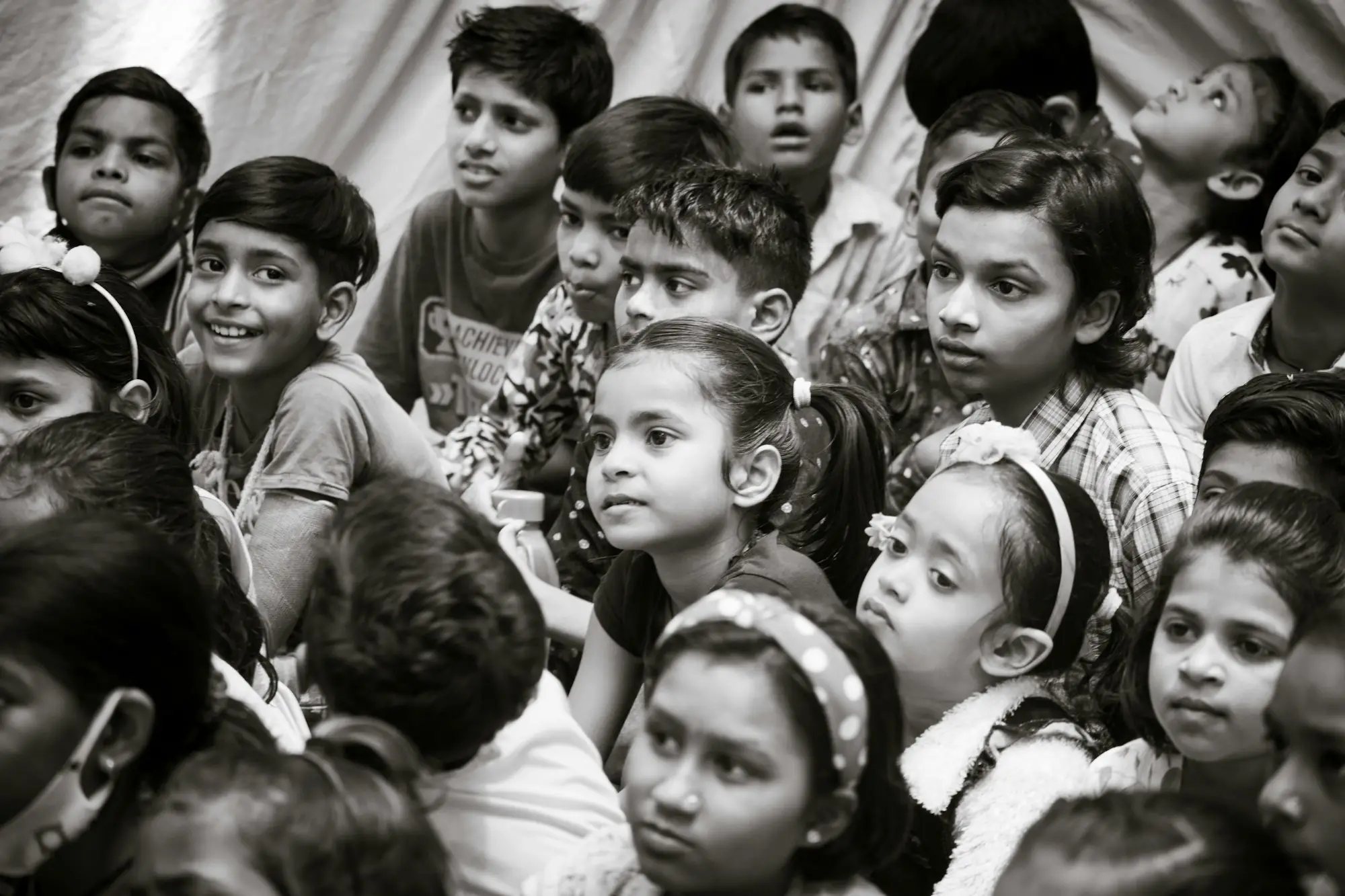 A group of schoolchildren gathered together, photographed in black and white